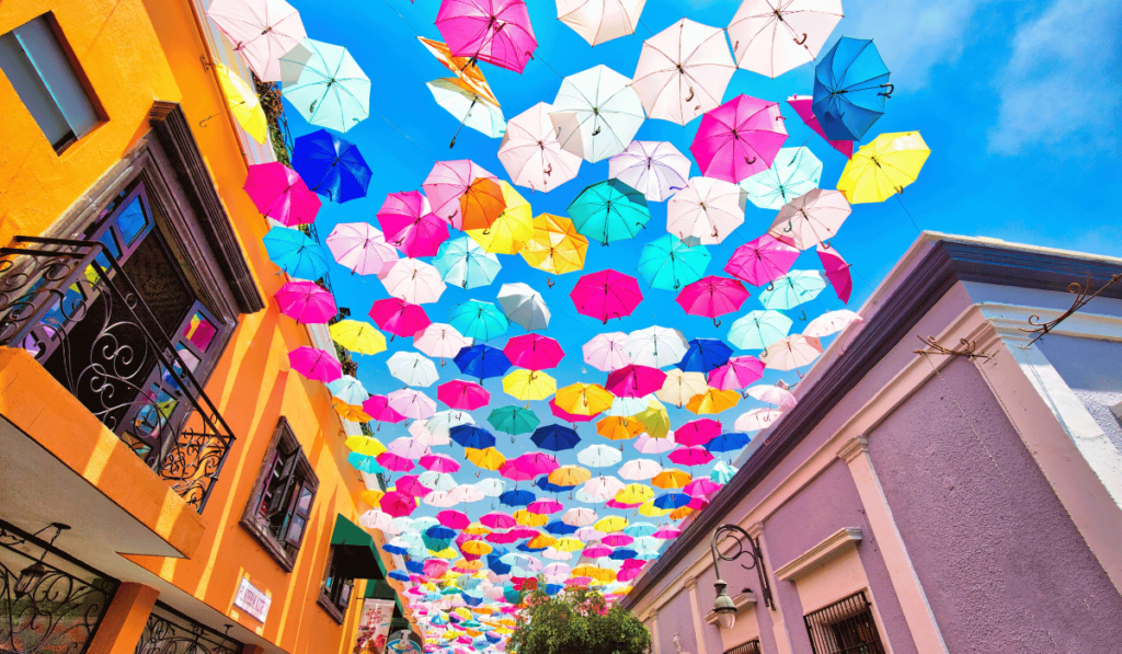 Colorful umbrellas suspended above the streets of Guadalajara, Mexico, creating a vibrant and artistic canopy of shade.